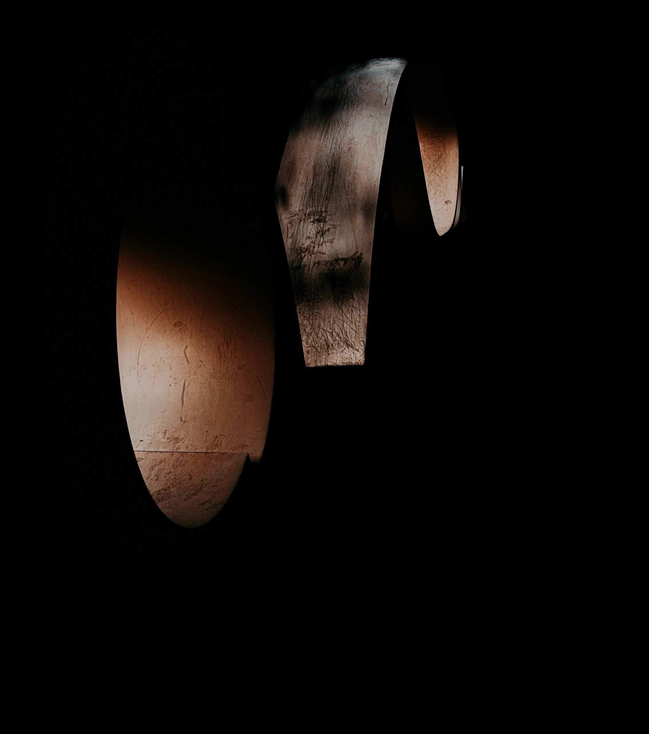 Deep black and brown abstract fine art photography print featuring two large, partially visible circular shapes and dramatic contrast, titled Circular Conversation.