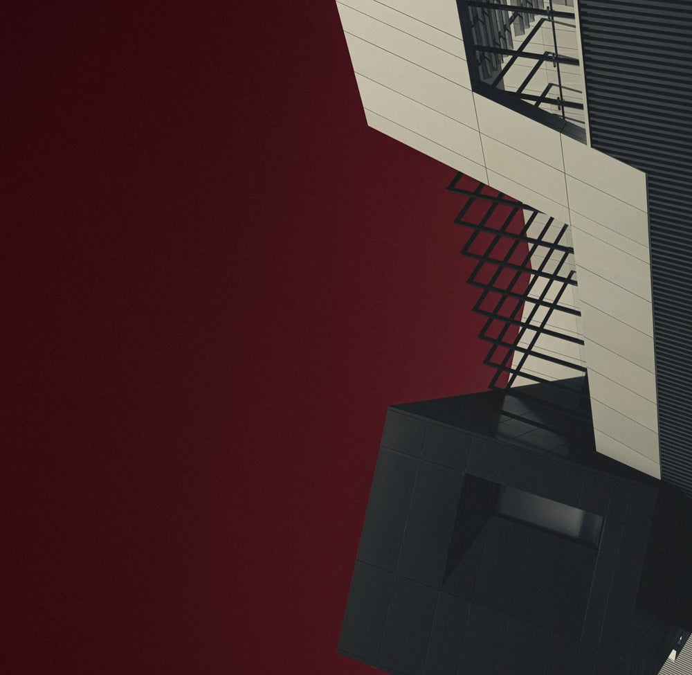 Intense deep red and black abstract architectural photography print with sharp, intersecting geometric forms, titled Shiraz.