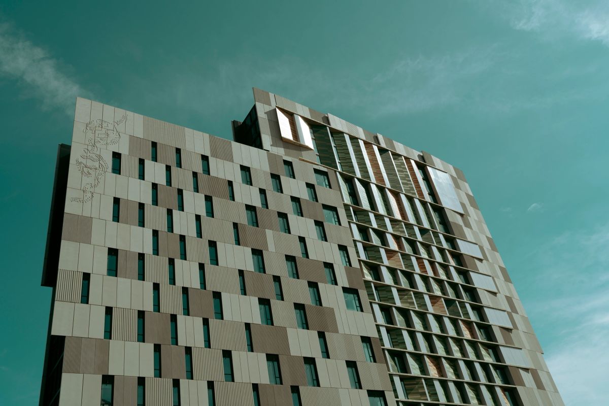 Abstract close-up photography print of an architectural detail resembling a flower or blossom on a factory wall, titled Factory Blossom.